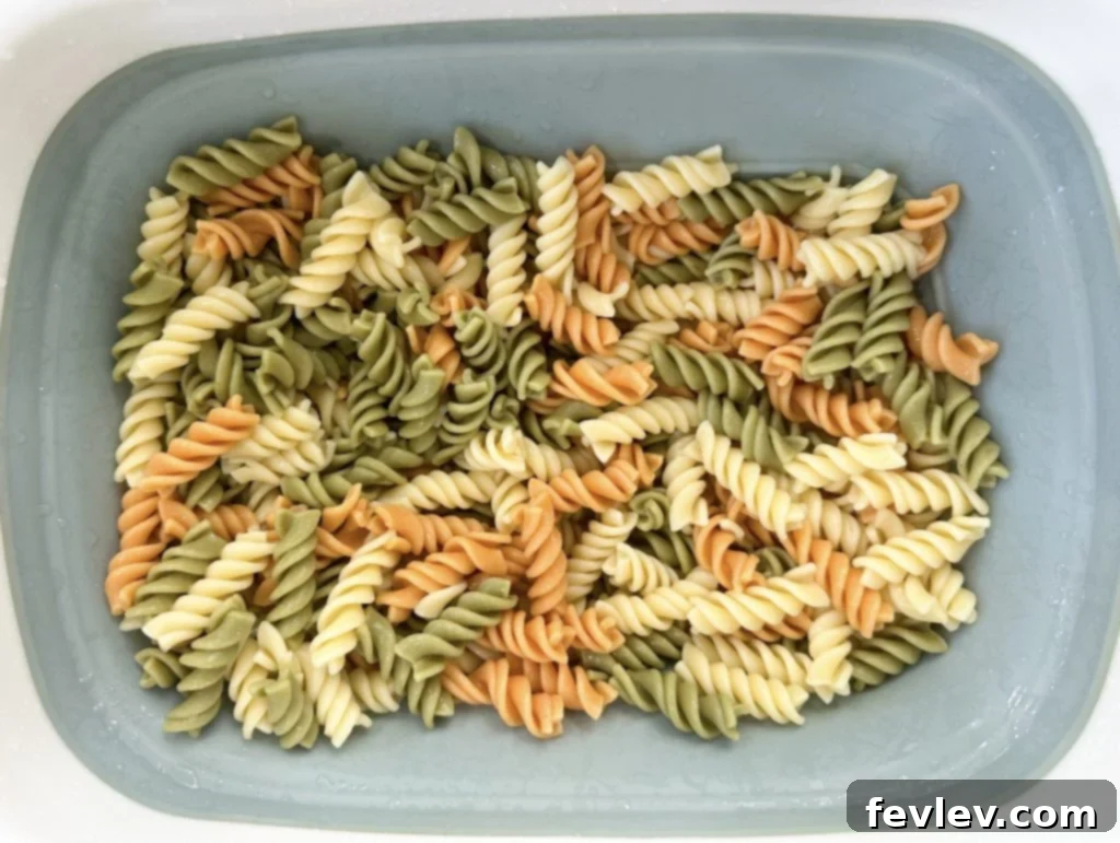 Ultimate Bacon Ranch Pasta 3 Cooked pasta being rinsed with cold water and cooled completely