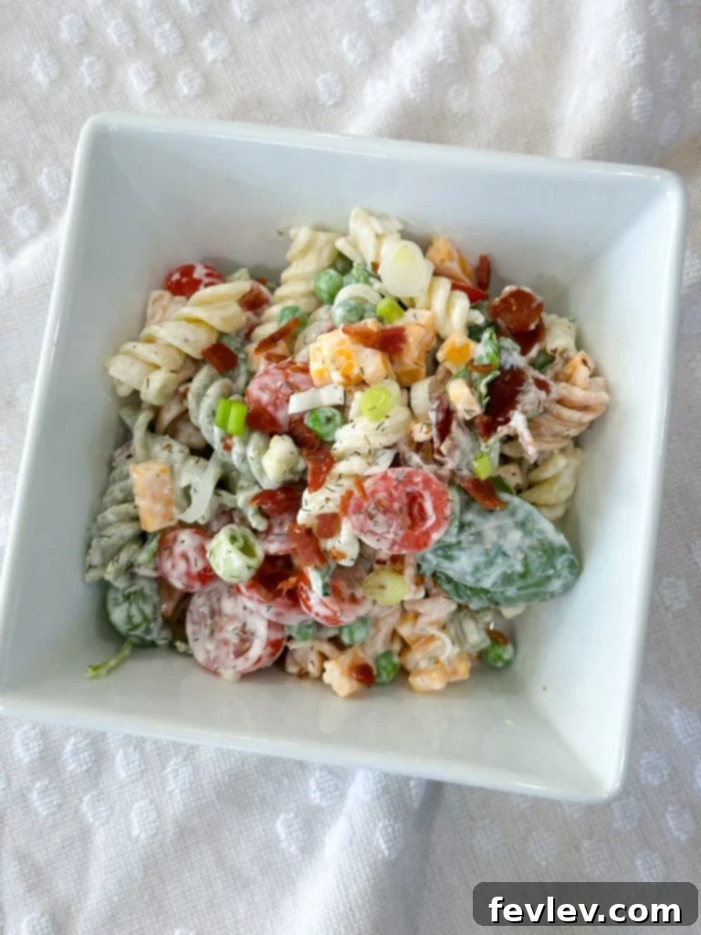Ultimate Bacon Ranch Pasta 7 A vibrant bowl of Ranch Bacon Pasta Salad with extra ingredients like bell peppers and corn for customization