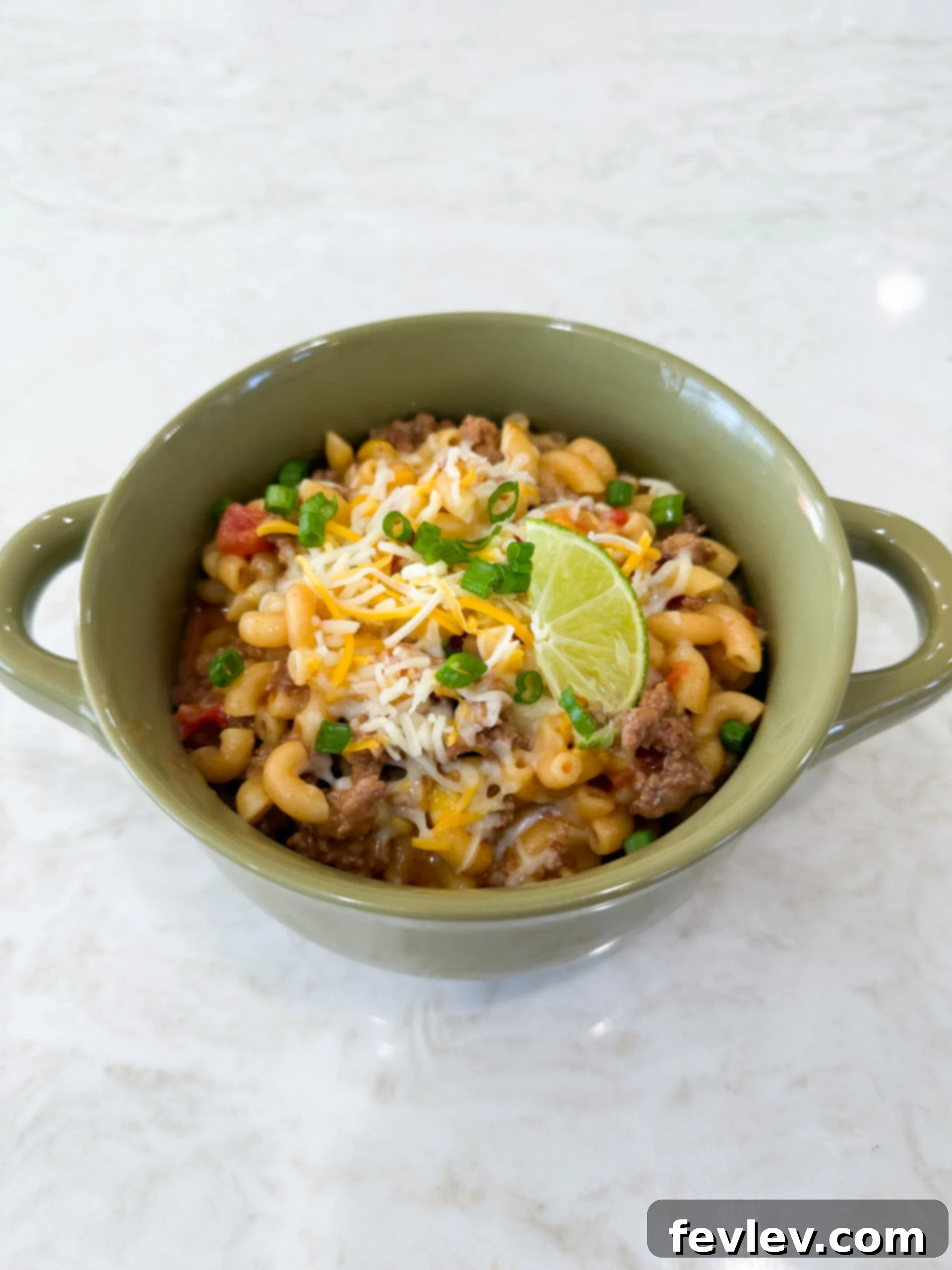Easy One-Pot Taco Pasta Skillet Dinner served in a rustic bowl, garnished with fresh cilantro.