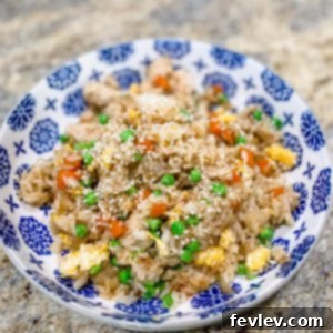 Vibrant Pineapple Fried Rice with tender chicken, colorful vegetables, and juicy pineapple pieces, served in a carved pineapple boat.