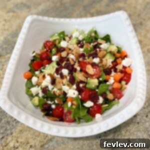 Vibrant Classic Side Salad with fresh greens, cherry tomatoes, avocado, and feta cheese, ready to serve.