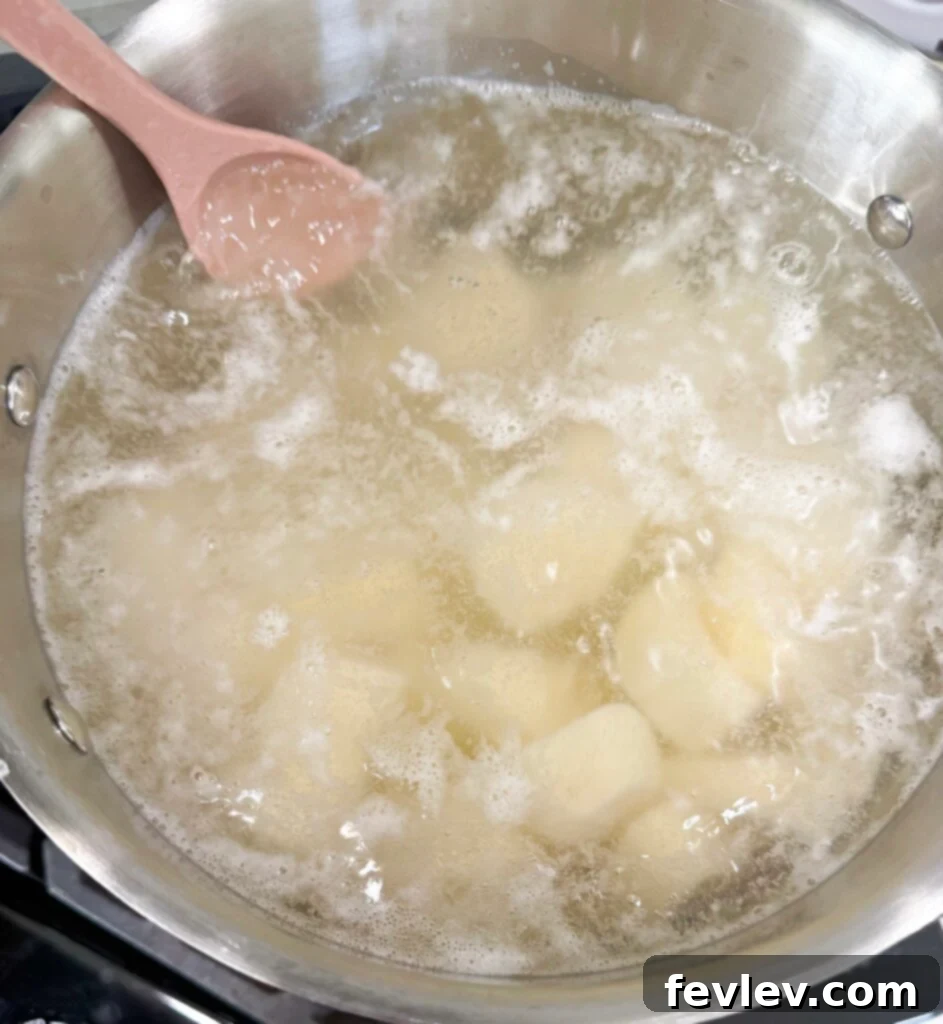 Double Delicious Potato Bake 3 Diced potatoes boiling in a large pot until fork-tender