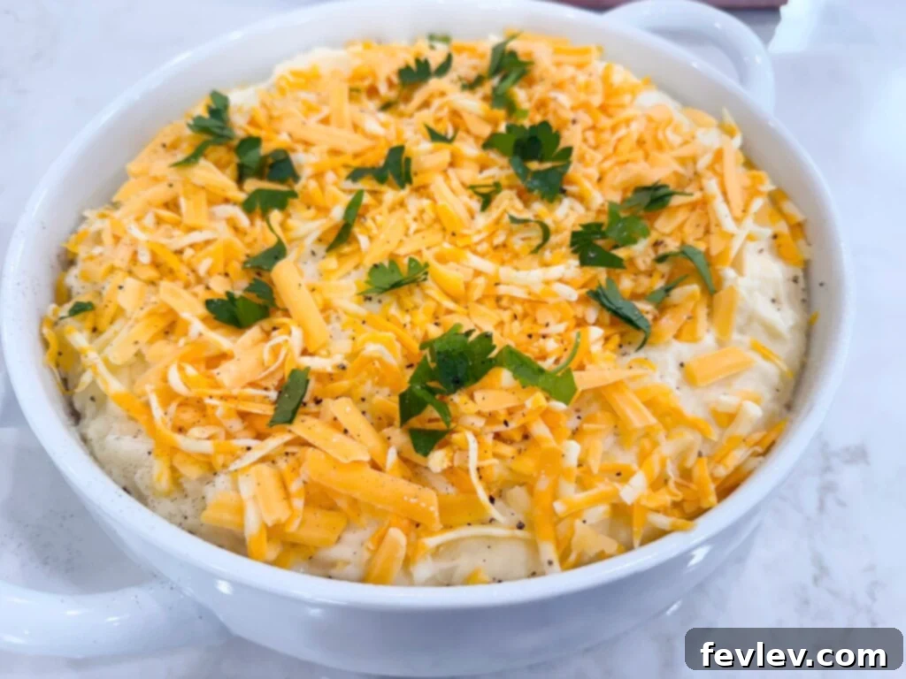 Double Delicious Potato Bake 6 Twice Baked Potato Casserole topped with extra shredded cheese before baking