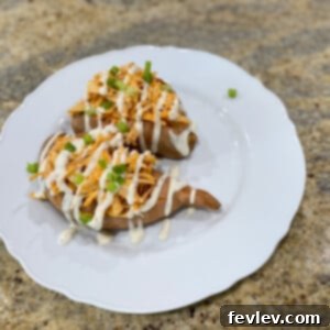 Delicious Buffalo Chicken Stuffed Sweet Potatoes with ranch drizzle and green onions