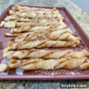 Golden brown cinnamon twists drizzled with a sweet vanilla glaze