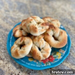 Golden brown garlic knots drizzled with melted garlic butter and fresh parsley