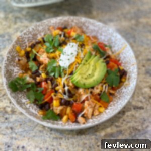 Vibrant Southwest Chicken Skillet featuring shredded chicken, black beans, corn, and bell peppers, garnished with fresh cilantro and lime