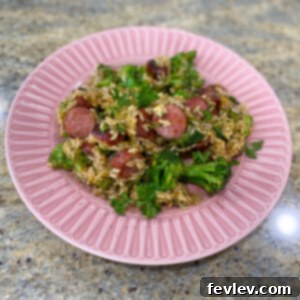 Delicious one-pot sausage and rice with tender broccoli florets, served hot in a skillet.