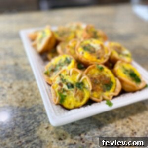 Delicious Mini Pie Crust Quiche Bites arranged on a platter, ready to serve.
