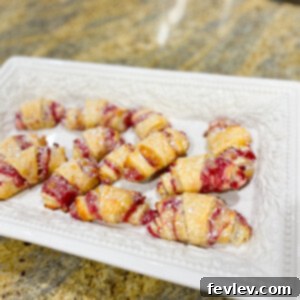 Delicious Raspberry Cream Cheese Roll Ups, golden brown and sprinkled with powdered sugar