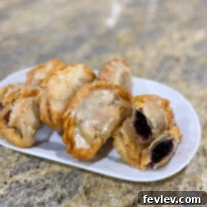 Delicious golden brown blueberry hand pie with a sweet glaze