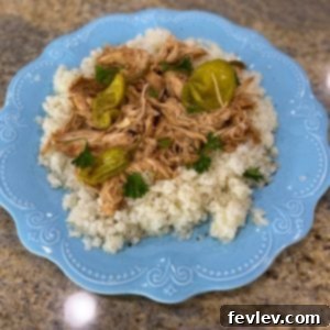 Delicious and easy Mississippi Chicken in a slow cooker, shredded and ready to serve.