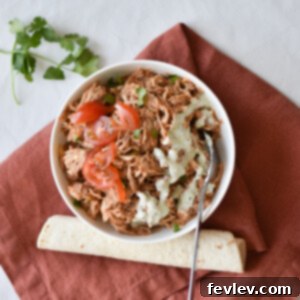 Delicious Sweet Pork Burritos ready to eat, garnished with fresh cilantro and lime