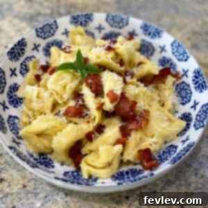 Delicious Tortellini Pasta Carbonara with crispy bacon and fresh herbs