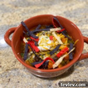 A vibrant bowl of Slow Cooker Vegetarian Chili with Sweet Potato and Black Beans, garnished with fresh cilantro and a dollop of sour cream, ready to be enjoyed.
