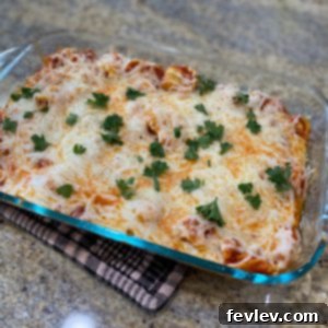 Delicious Baked Tortellini topped with melted cheese and fresh parsley in a baking dish