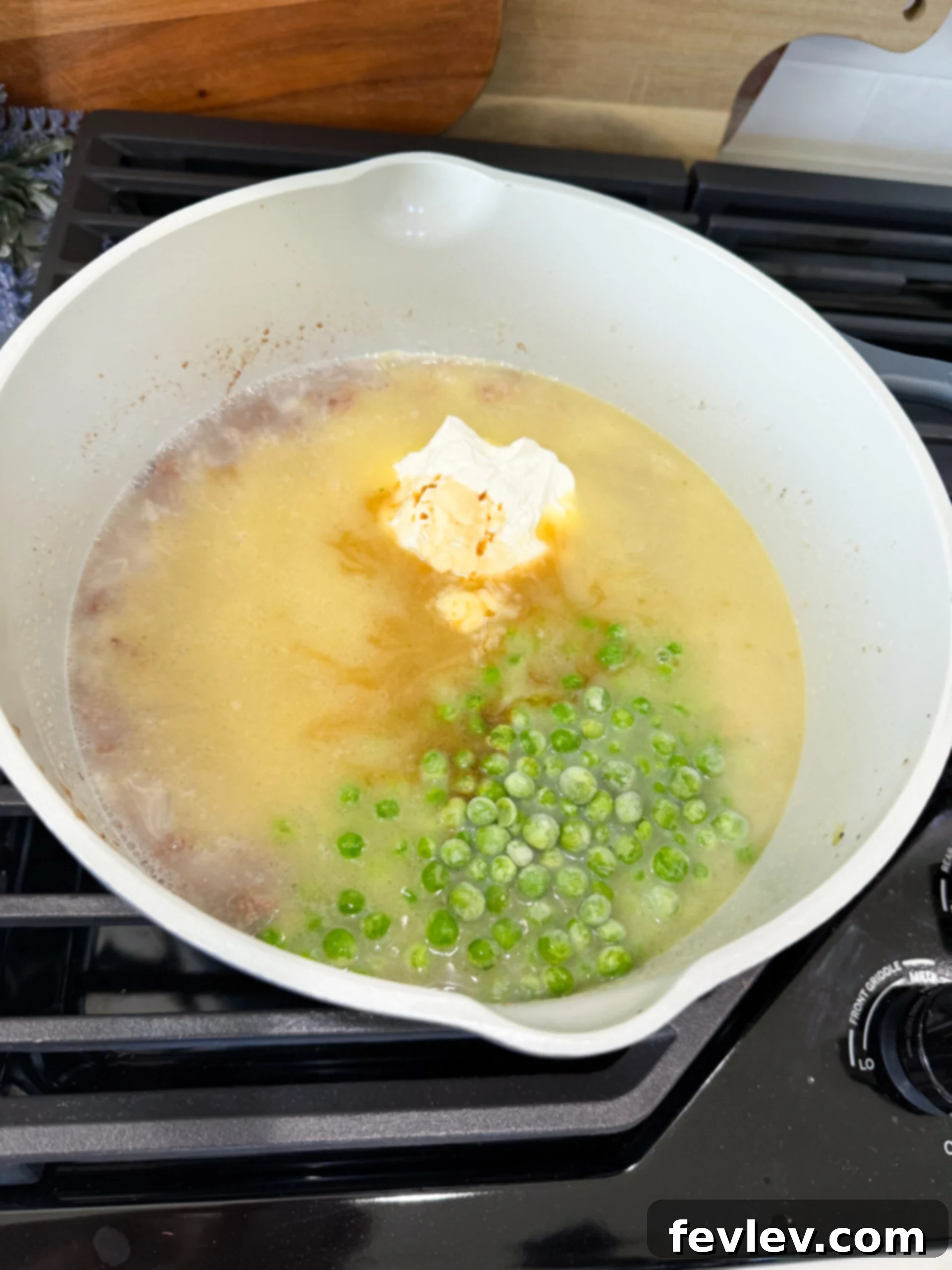 Creamy stroganoff sauce with ground beef, peas, and half the cheese stirred in, before adding noodles