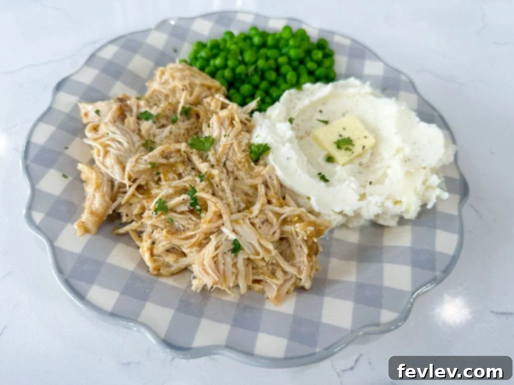 Shredded slow cooker chicken and gravy in the pot, perfectly cooked and ready to dish out