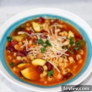 Slow cooker minestrone soup in a bowl with Parmesan