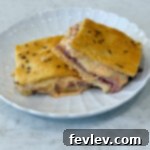 A savory pastrami crescent sandwich bake, featuring layers of pastrami and cheese in a flaky crescent roll crust.