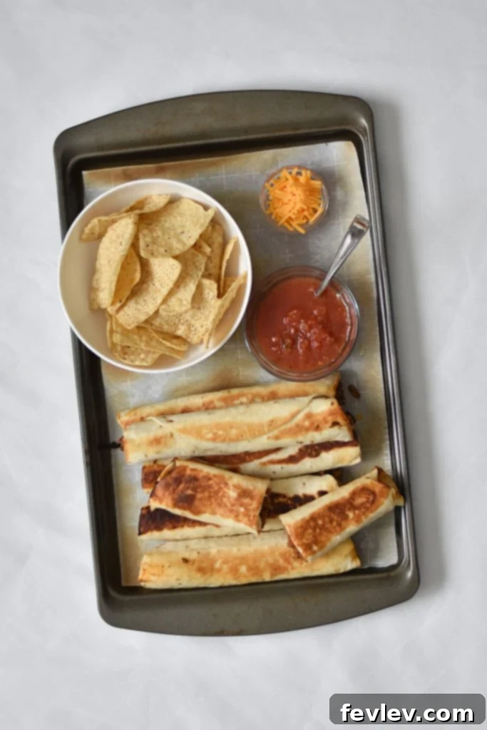 Close-up of a beef taquito revealing the rich seasoned ground beef and melted Mexican-style cheese filling.