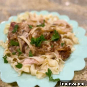 Delicious and tender slow cooker pork chops served with a creamy mushroom gravy, perfect for a cozy family dinner.