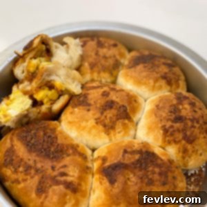 Golden Bacon Egg and Cheese Morning Puffs 2 Golden brown Bacon, Egg, and Cheese Breakfast Bombs arranged in a round pan