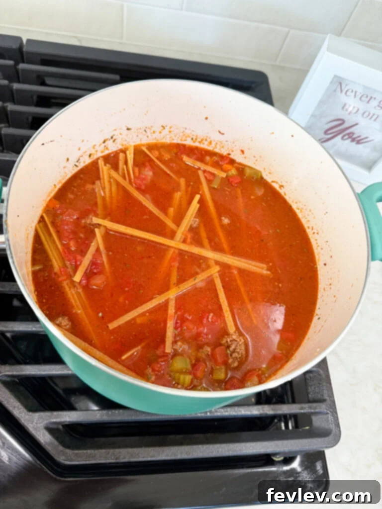 One-Pot Beef Bolognese simmering gently in a Dutch oven, with pasta absorbing the rich tomato sauce.