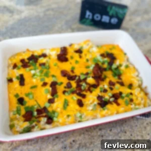 Delicious and creamy Crack Chicken Casserole topped with melted cheese, crispy bacon, and fresh green onions