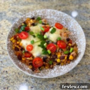 A vibrant, delicious Loaded Enchilada Casserole, freshly baked and topped with melted cheese.