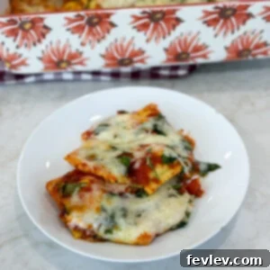 Baked cheese ravioli casserole topped with herbs and melted cheese, ready to serve.