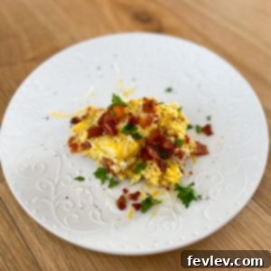 Delicious and cheesy bacon and egg crockpot casserole ready to be served, garnished with fresh herbs.
