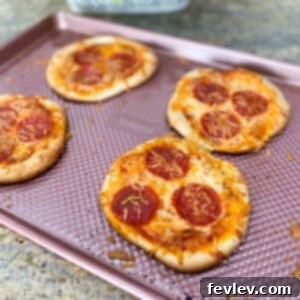 Delicious personal pizzas made with golden-brown roll dough, topped with melted cheese and pepperoni.