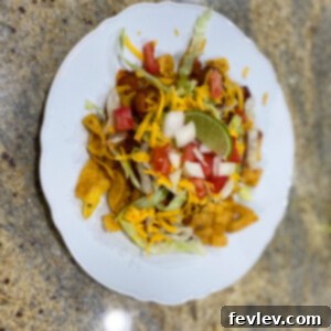 Delicious 20-minute Frito Pie with chili, cheese, and fresh toppings