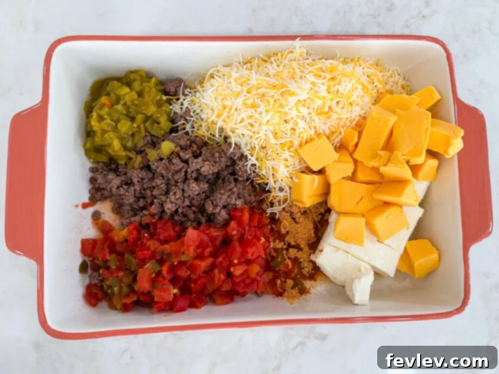 Epic Loaded Baked Queso 4 Adding queso ingredients to a baking dish