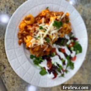 Delicious Sausage Tortellini in a rich, creamy tomato sauce, garnished with fresh herbs.