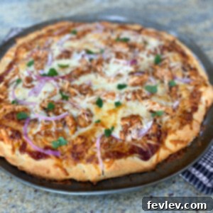 A delicious and easy-to-make 2-Ingredient Pizza Dough BBQ Chicken Pizza with melted cheese and fresh toppings.