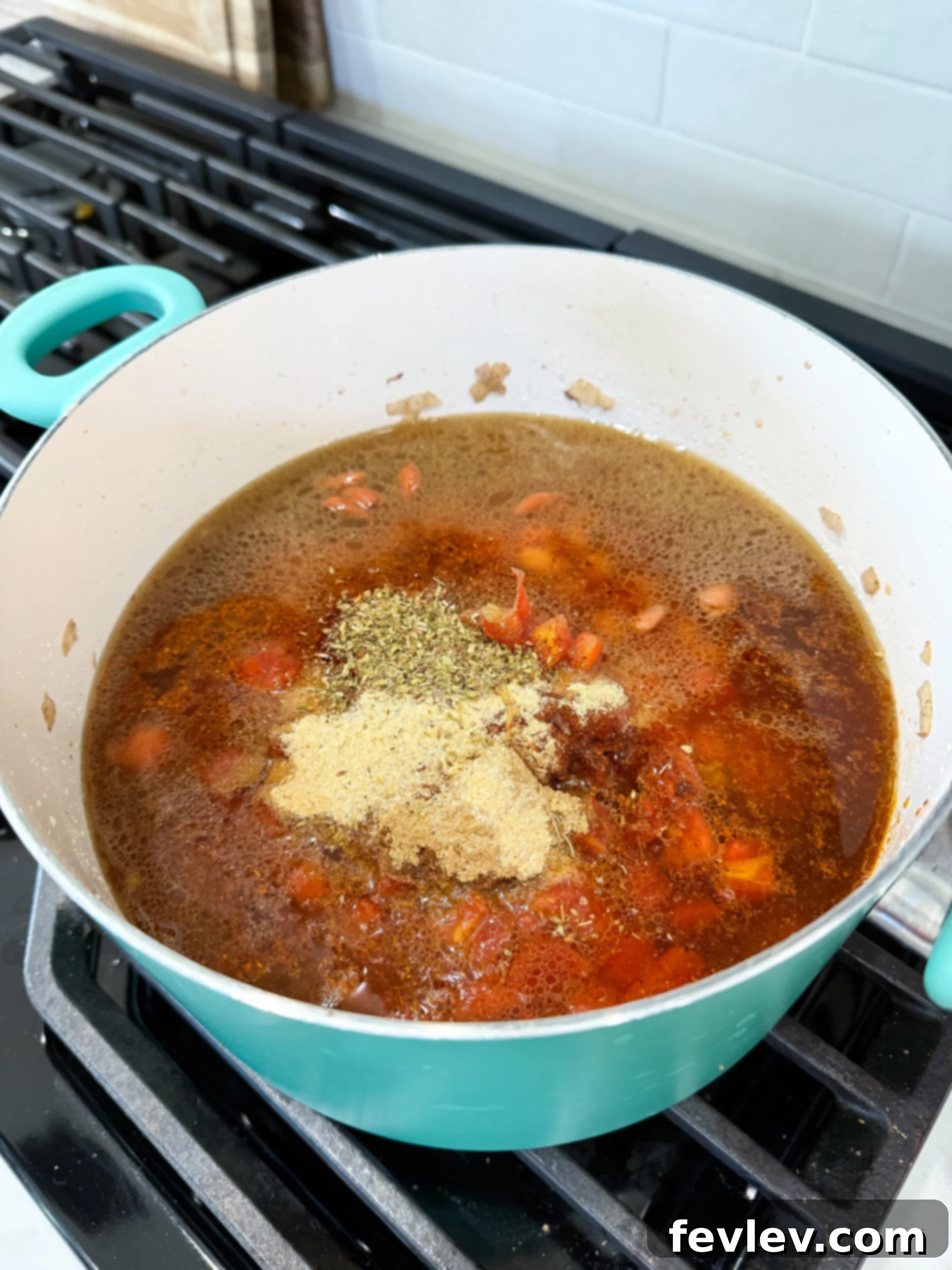 Golden Queso Chili 6 Ground beef and diced onions cooking in a large pot with olive oil, browning evenly