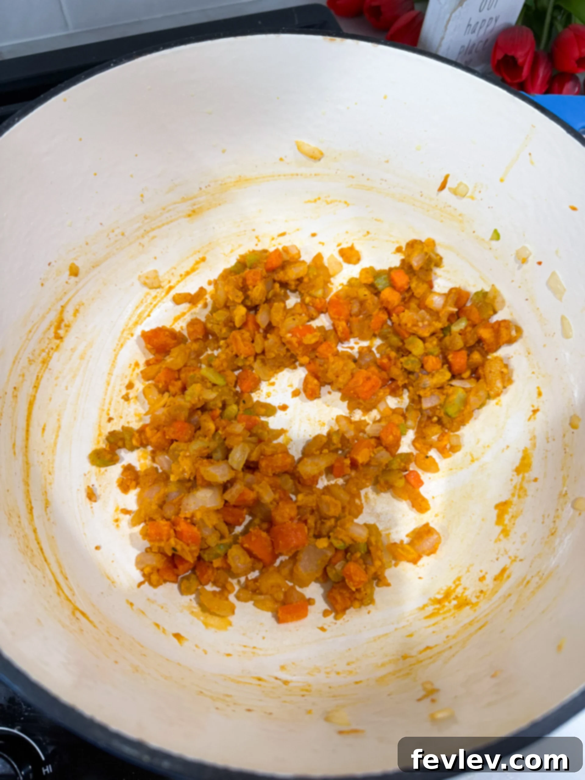 Flour sprinkled over vegetables in a pot