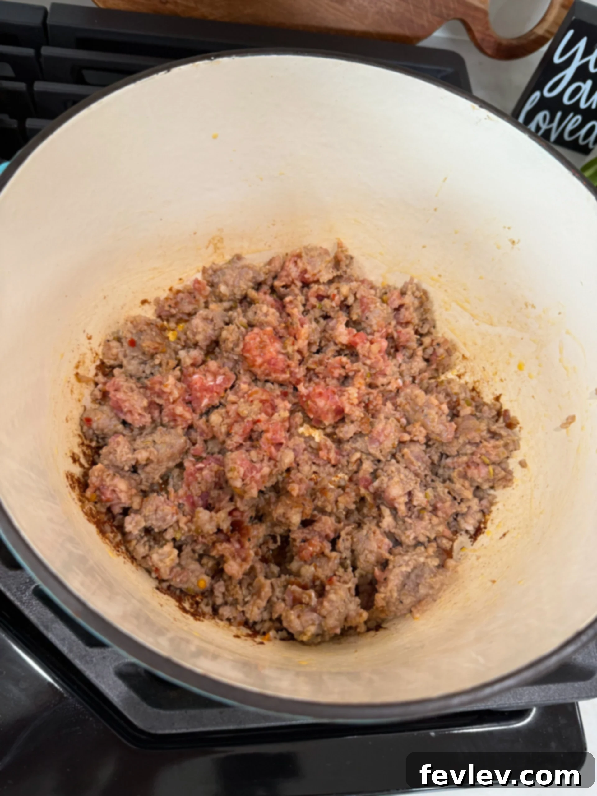 Browning sausage in a pot for sausage potato soup.