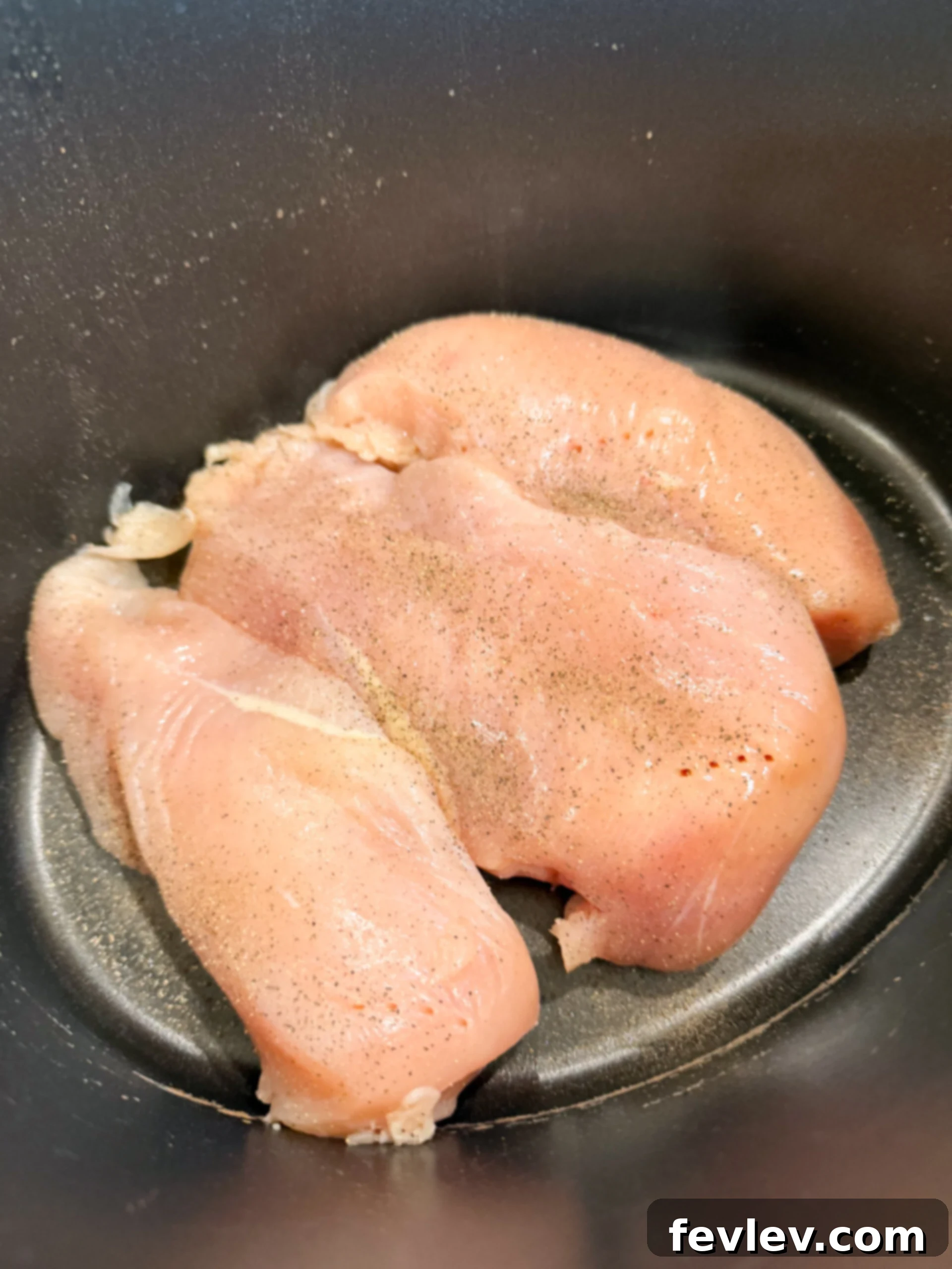 Chicken breasts placed in slow cooker