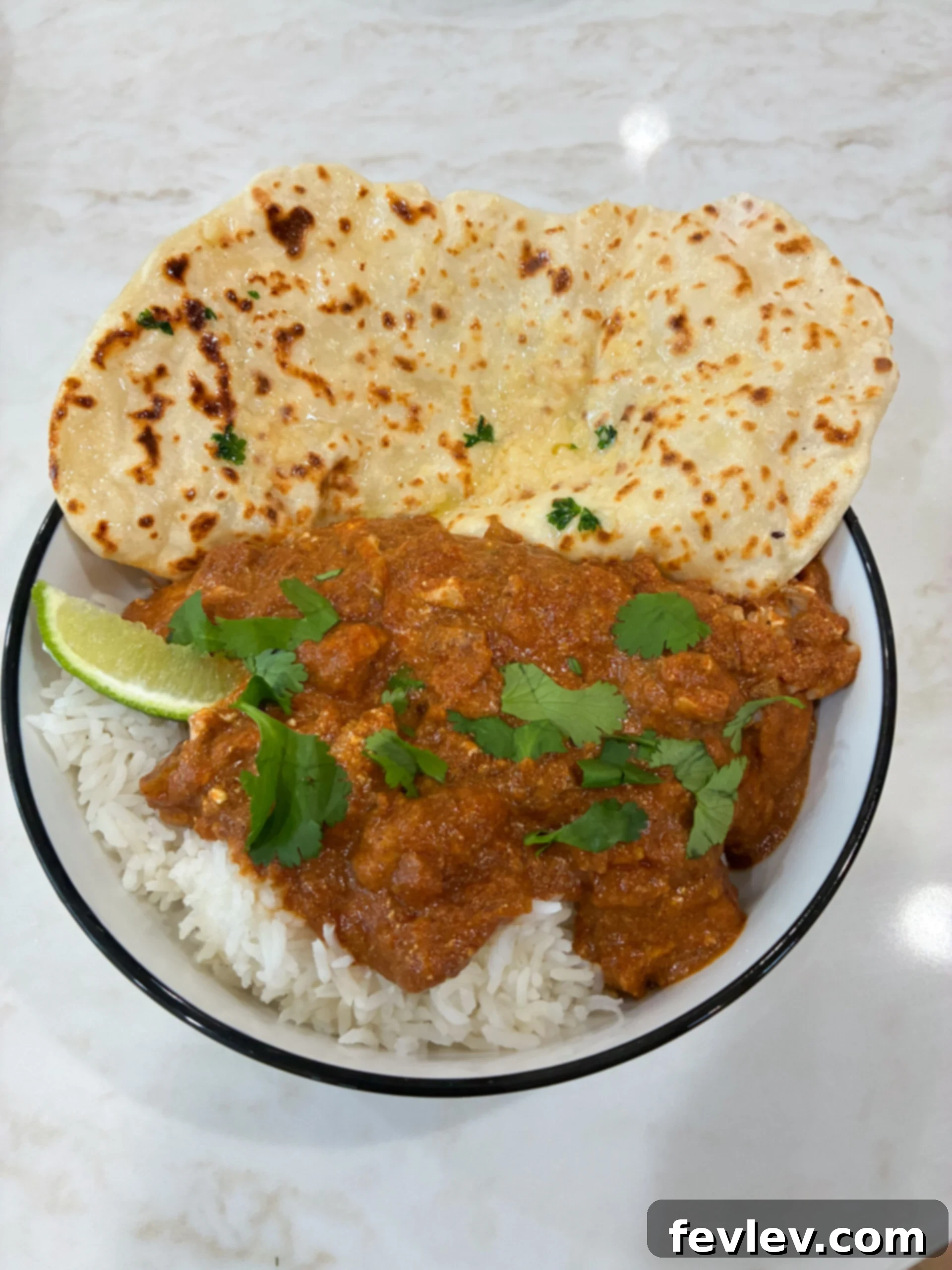 Slow Cooker Butter Chicken Bliss 2 Butter chicken served with rice and naan bread