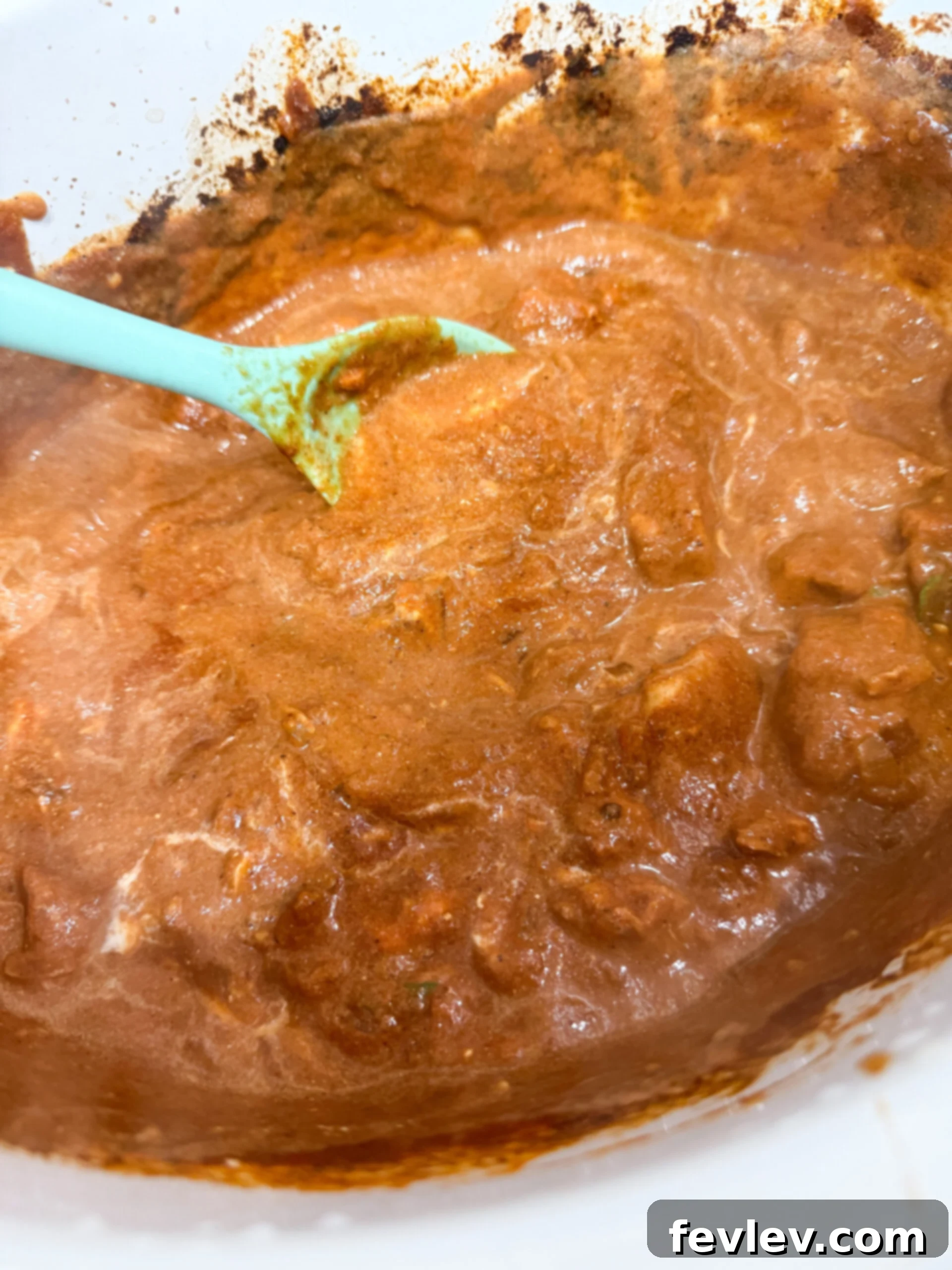 Slow Cooker Butter Chicken Bliss 6 Yogurt and half and half being stirred in