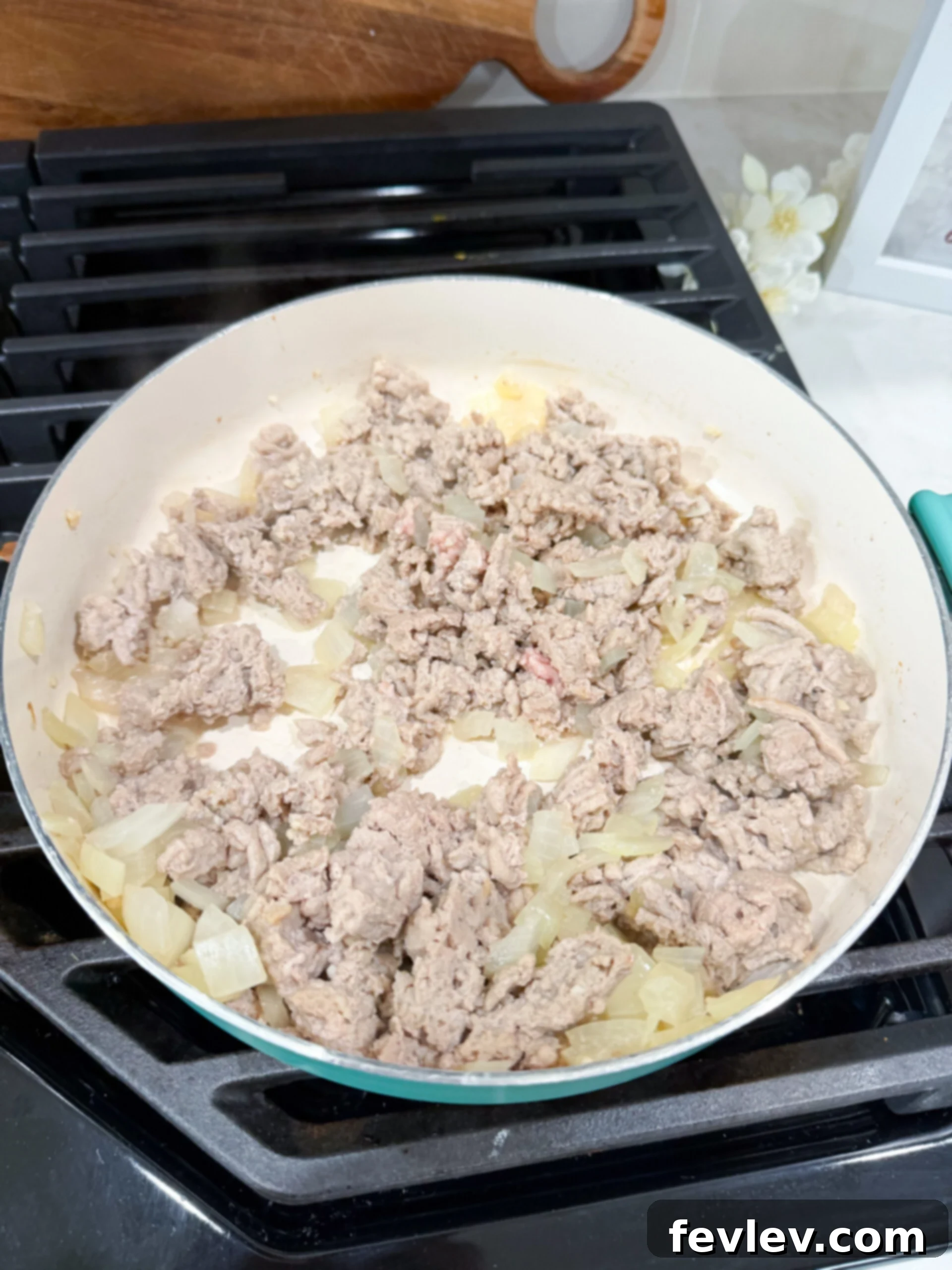 Ground turkey and onion cooking in a skillet