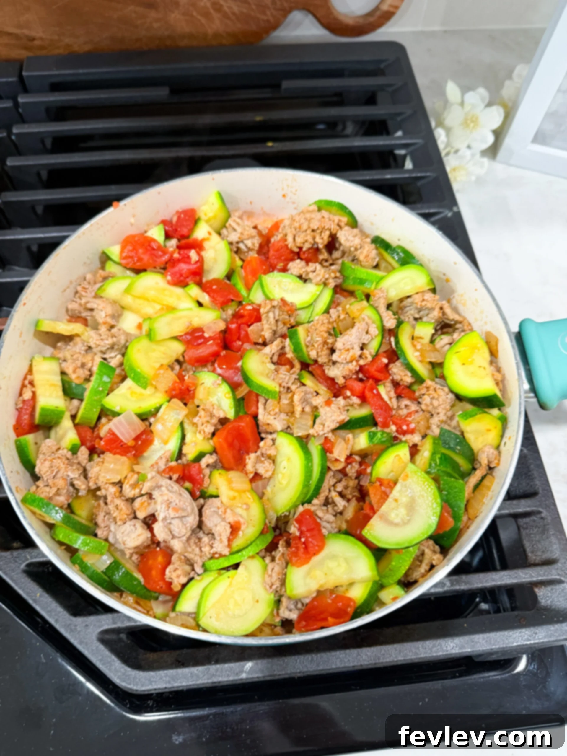 Zucchini and tomatoes added to skillet with turkey