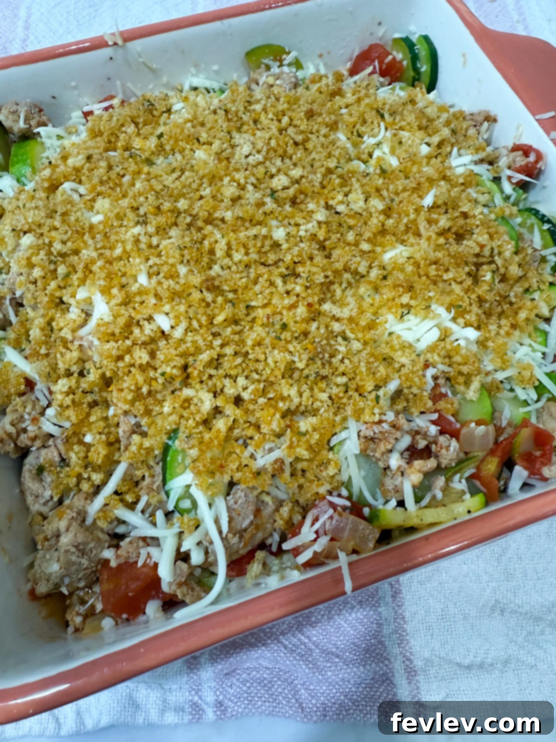 Unbaked casserole with breadcrumb topping
