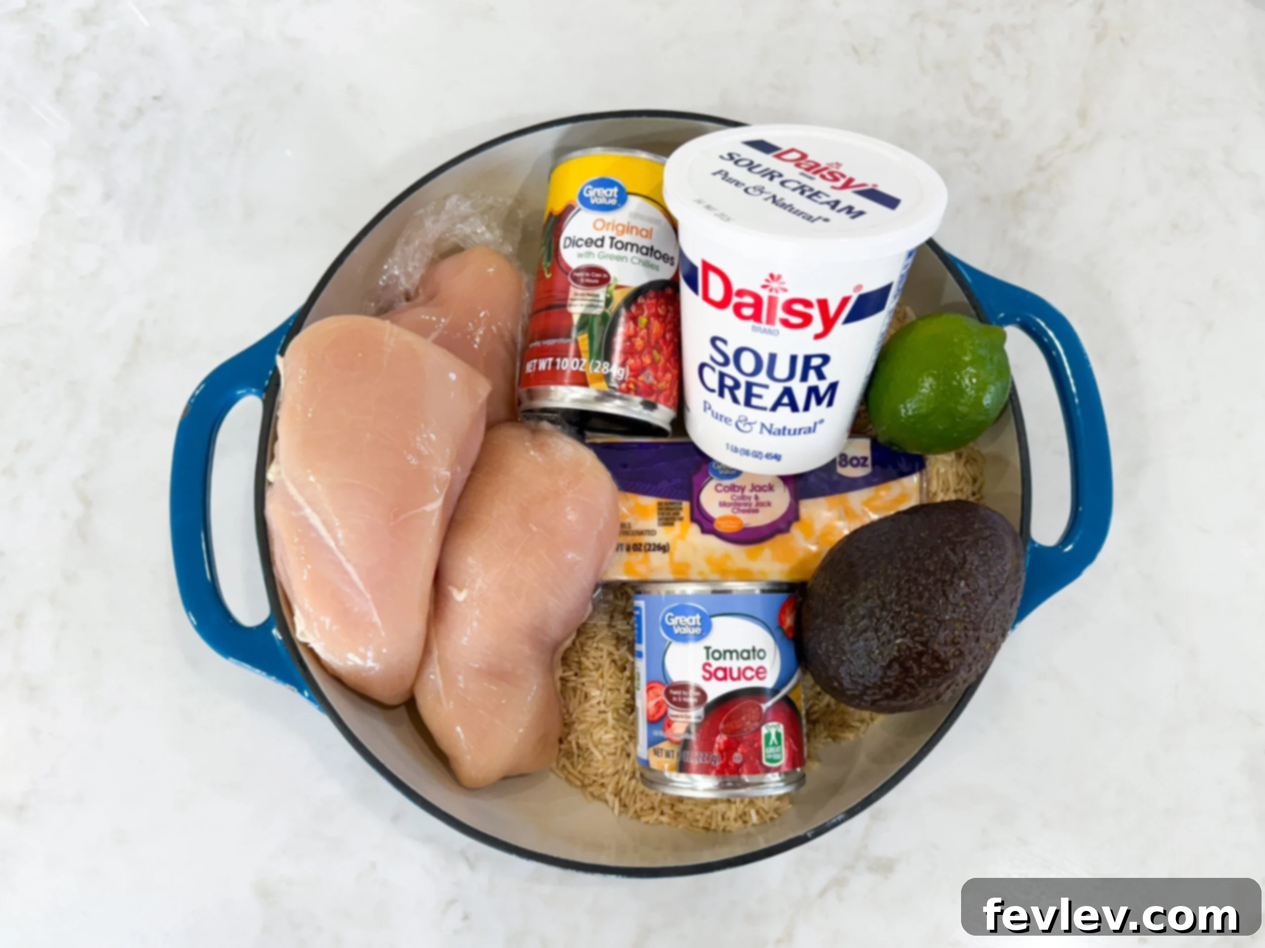 Ingredients for chicken taco rice in a skillet